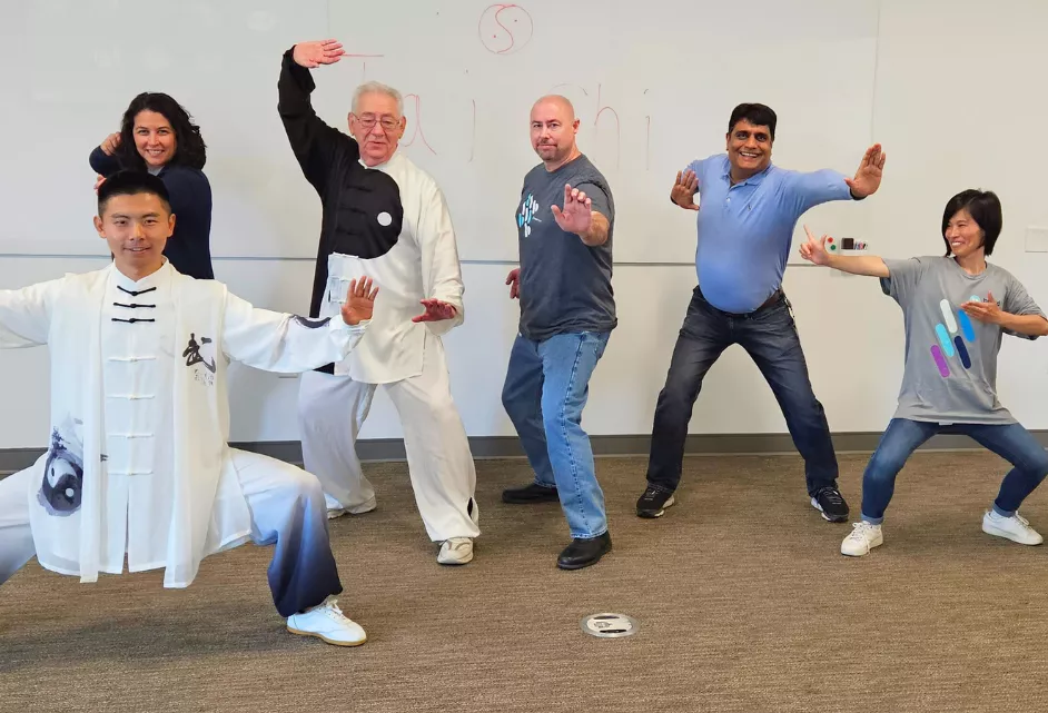 Members of the Asian Alliance BRG showcase Tai Chi poses during a class hosted by Bread Financial as part of Asian Heritage Month and Mental Health Awareness Month.