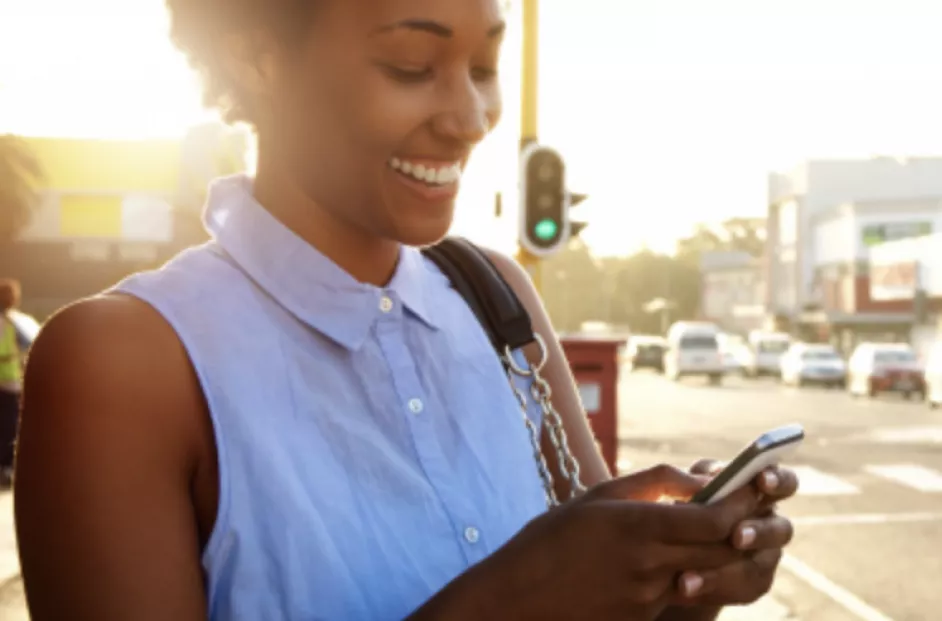 Woman looking at phone on the street