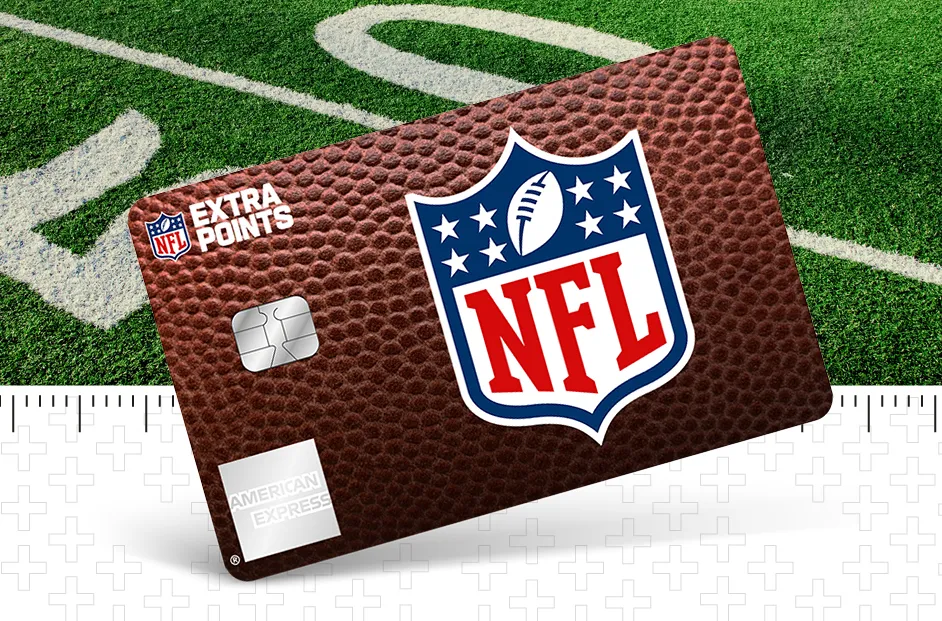 American Express NFL Extra Points credit card with a football-textured design displayed at an angle on a green football field. The card features the NFL shield logo prominently in the center, the NFL Extra Points logo in the upper left corner, a payment chip on the left side, and American Express branding in the lower left corner. A football field yard line and a ruler-style graphic border are visible in the background.