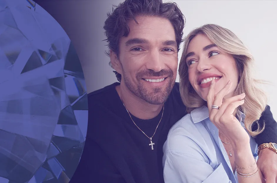 Promotional image featuring two people wearing fine jewelry, including rings, necklaces, bracelets, and a watch. A large blue gemstone graphic appears on the left side of the image, while the jewelry models are shown against a light background displaying several jewelry pieces.