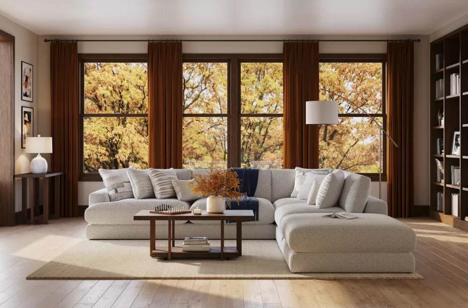 Stock image of a well decorated living room with fall foliage featured in the window.