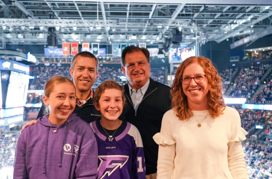 Bread Financial President and CEO Ralph Andretta pictured with the Daubenmire family at a Columbus Blue Jackets game.