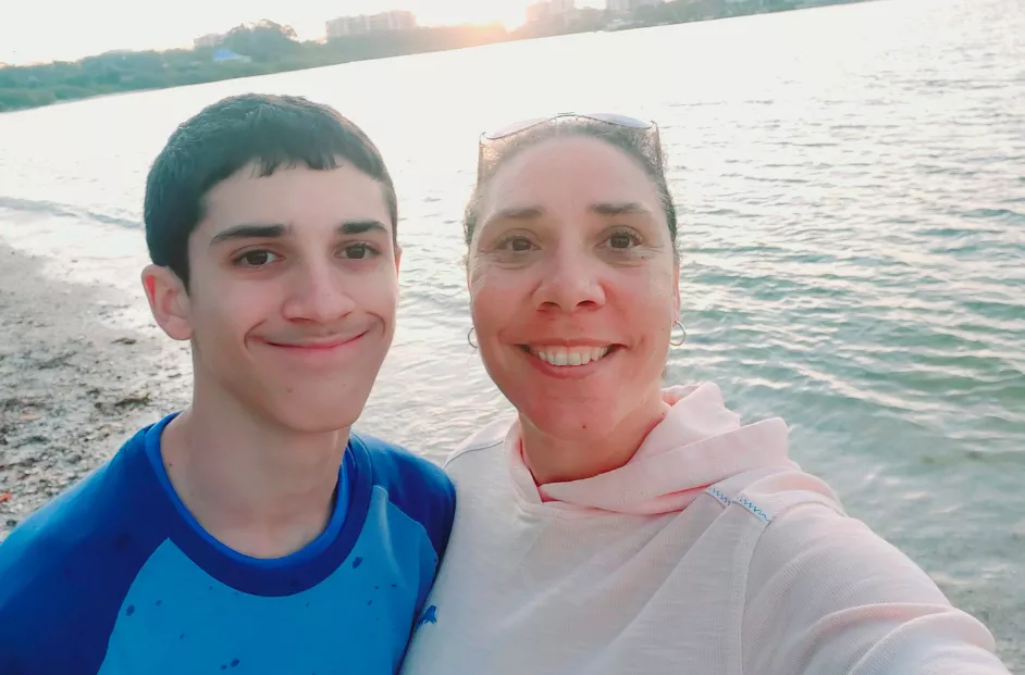 Tez Reardon, senior manager of DE&I at Bread Financial, takes a selfie on the beach with her son, Tyson.
