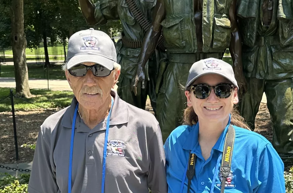 Photo of Kayla Bollinger and a veteran at the war memorial in Washington D.C.