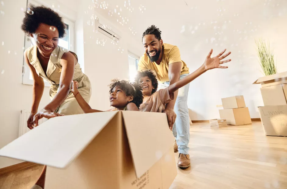 Family of four unpacks boxes in their new home.