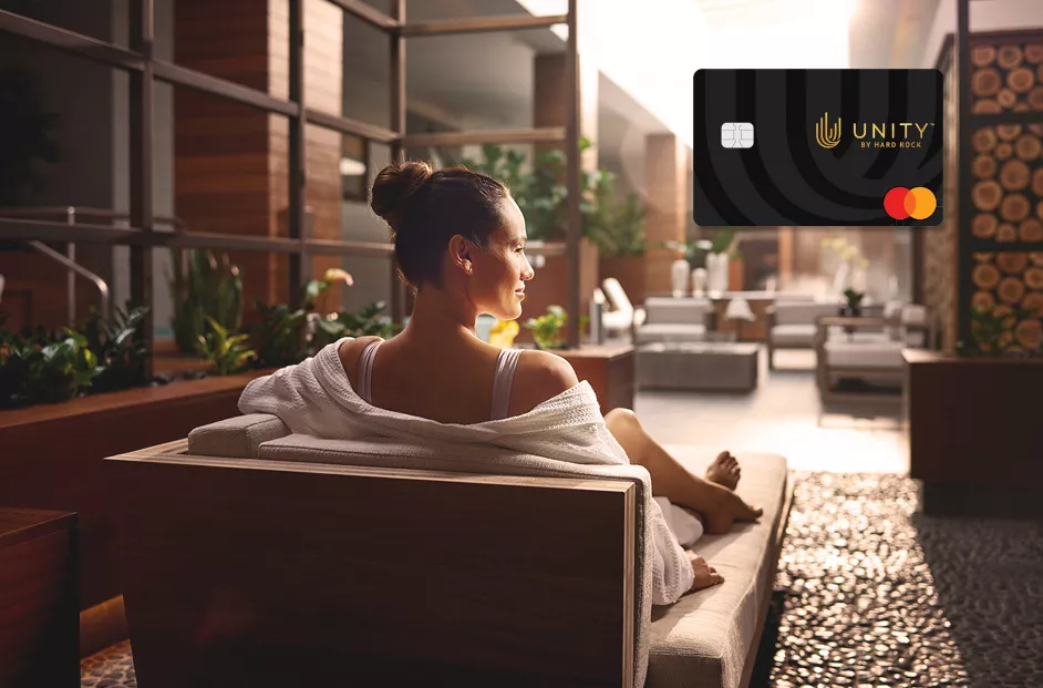 A woman relaxes in a spa setting. Image of the Unity by Hard Rock Mastercard included.