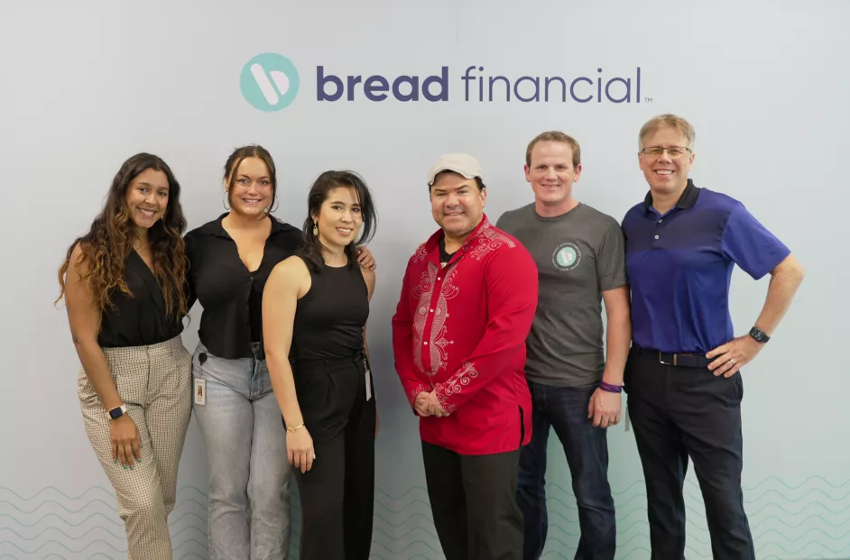 Six-person group photo with the Bread Financial logo