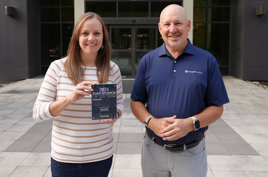 Lindsay Madaras, senior manager of associate well-being, and Perry Beberman, executive vice president and chief financial officer, pictured with the PlanSponsor of the Year Award at Bread Financial's Columbus, Ohio office.