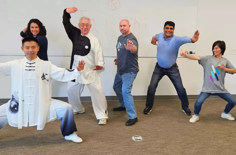 Members of the Asian Alliance BRG showcase Tai Chi poses during a class hosted by Bread Financial as part of Asian Heritage Month and Mental Health Awareness Month.