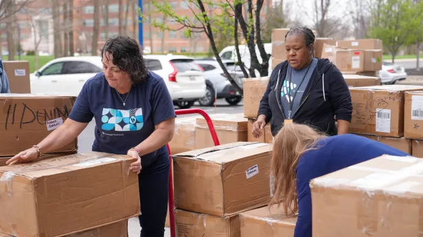 Bread Financial volunteers load boxes of clothing for distribution to ROX program facilitators and area educators and non-profit leaders.