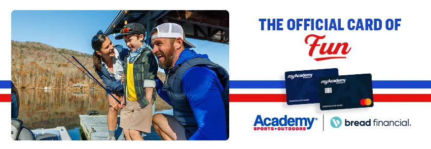 Three people stand on a wooden dock beside a calm lake, helping a child step toward a small boat while holding fishing rods. Autumn trees line the shoreline in the background. To the right, branded graphics read “The Official Card of Fun” with Academy Sports + Outdoors and Bread Financial logos alongside two credit cards.