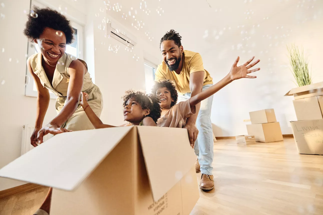 Family of four unpacks boxes in their new home.