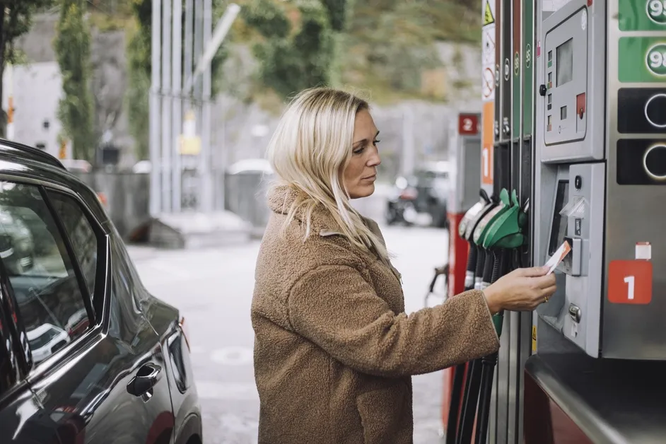 Woman paying at the pump