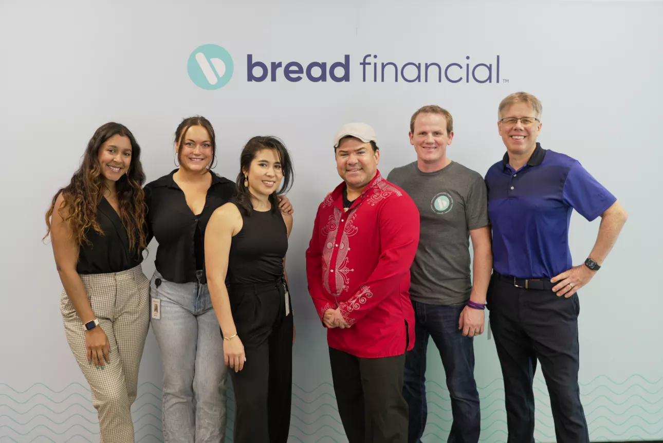 Six-person group photo with the Bread Financial logo