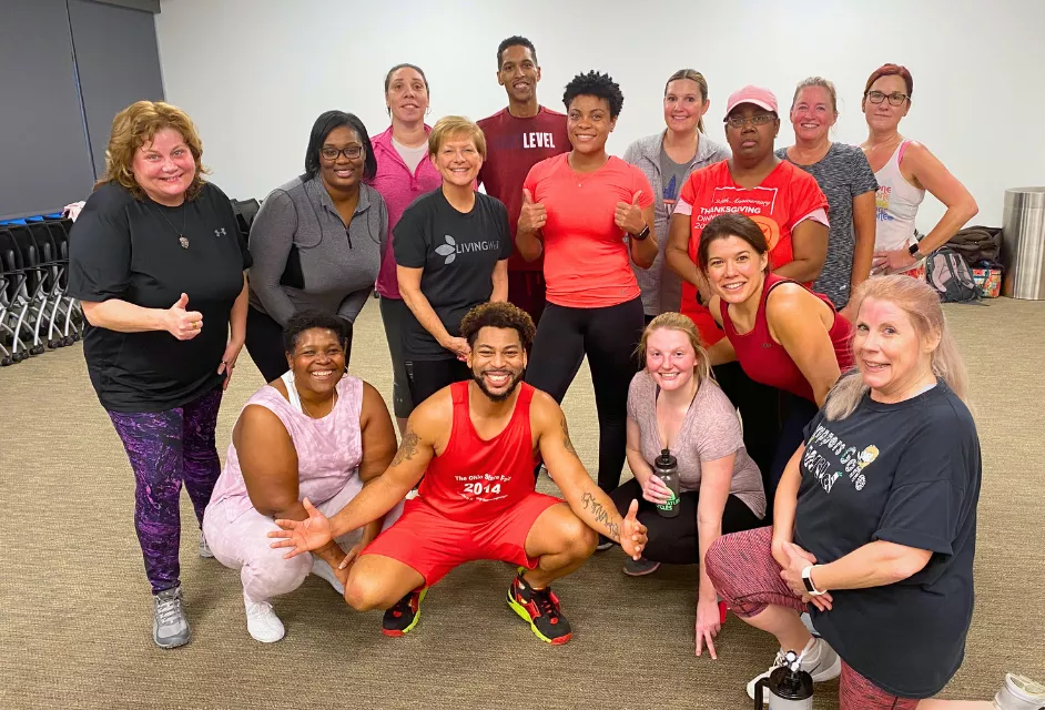 Associates pose for a group photo after a Hip-Hop workout class.