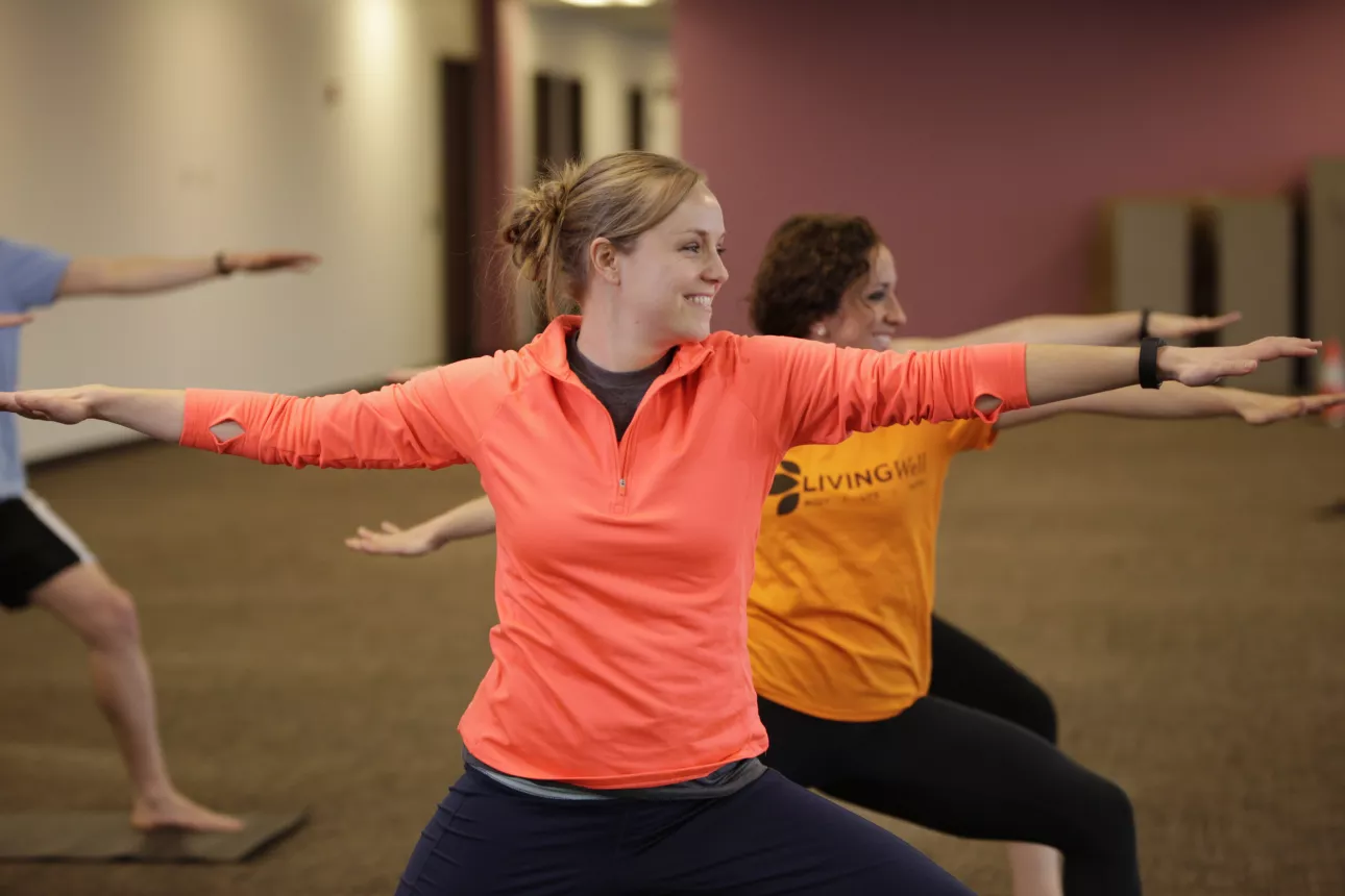 Associates participate in a Yoga class.
